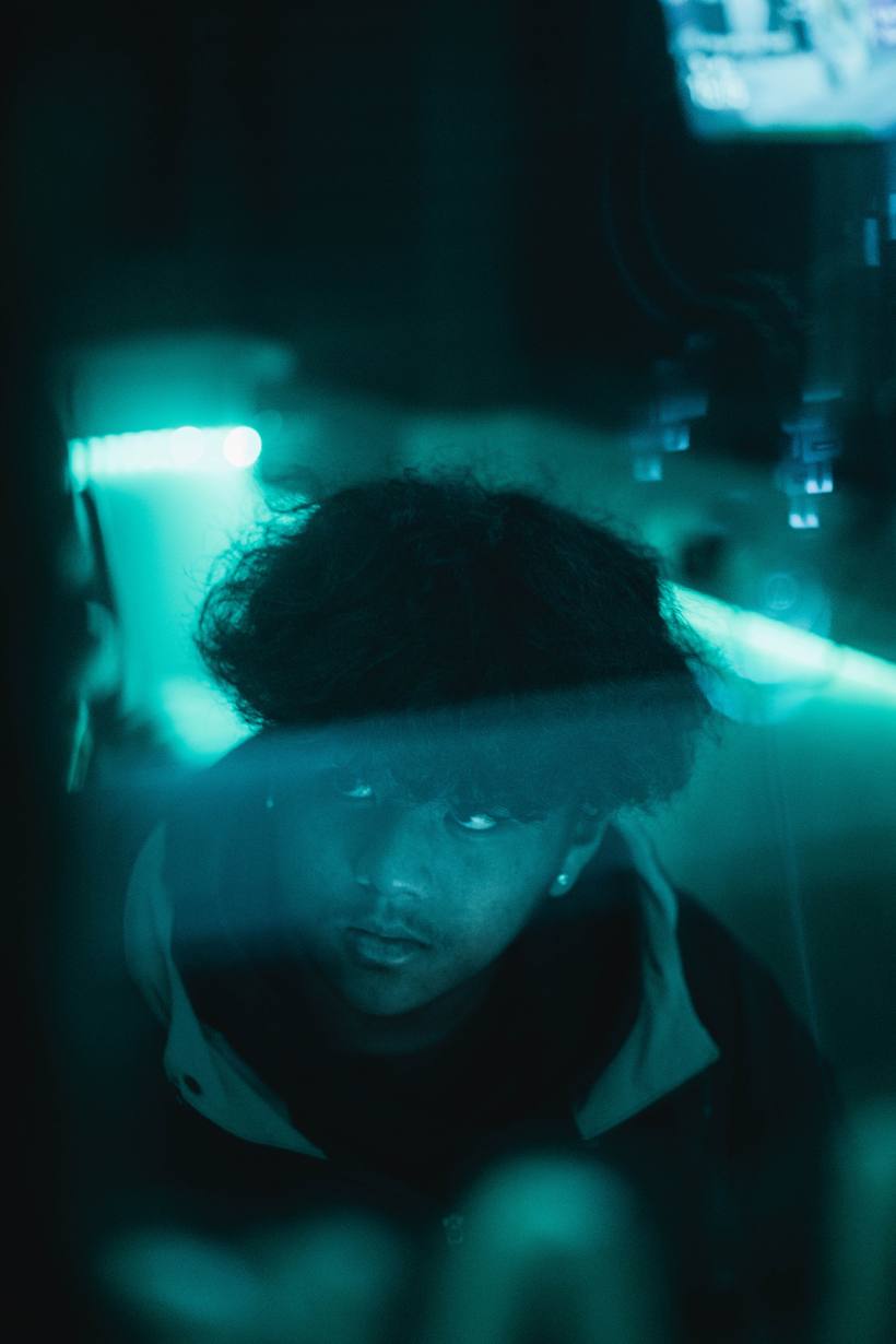 DreiGuapo in the studio, lit by teal light